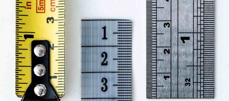 Yellow tape measure and two metal rulers